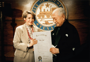 MR. RYOICHI SASAKAWA RECEIVING PROCLAMATION FROM HOUSTON MAYOR KATHY WHITMIRE DEDICATING "INTERNATIONAL SPACE ARCHITECTURE DAY", JUNE 3, 1987